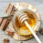 pile-of-cinnamon-sticks-and-jar-of-honey