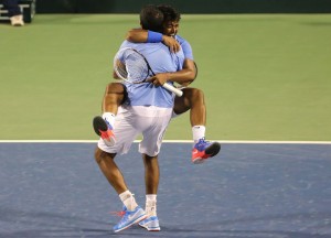 India's Leander Paes, facing camera, hugs his partner Rohan Bopanna to celebrate their win against Serbia's Nenad Zimonjic and Ilija Bozoljac during their Davis Cup tennis World Group play-off tie between India and Serbia, in Bangalore, India, Saturday, Sept. 13, 2014. Paes and Bopanna won the match 1-6, 6-7 (4-7), 6-3, 6-3, 8-6. (AP Photo/Aijaz Rahi)