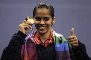 India's Saina Nehwal poses with her gold medal after winning the women's singles badminton finals at the Commonwealth Games in New Delhi October 14, 2010. REUTERS/Krishnendu Halder (INDIA - Tags: SPORT BADMINTON)