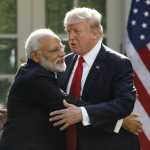 India’s Prime Minister Modi hugs U.S. President Trump as they give joint statements in the Rose Garden of the White House in Washington