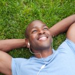 eshomdds-black-man-resting-on-grass-wearing-headphones