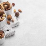 white-small-bowls-filled-with-assortment-nuts-copy-space