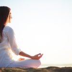 woman-sitting-yoga-pose-beach