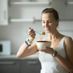 sporty-woman-eating-tree-pose