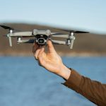 man-s-hand-holding-drone-outdoors