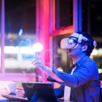 asian-young-male-wearing-wearable-goggle-headset-virtual-online-meeting-digital-space-working-with-3d-augmented-dimension-homecyber-virtual-working-with-virtual-vr-goggle-pc-desktop-device
