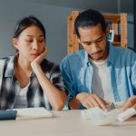 stressed-asian-couple-man-woman-use-calculator-calculate-family-budget